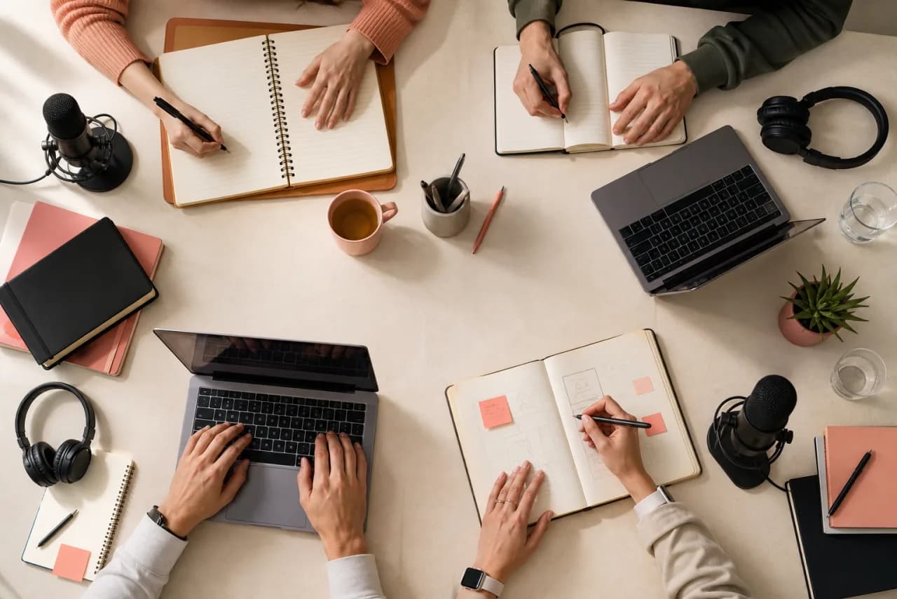 Four distinct voice-writing workspaces arranged around one shared table