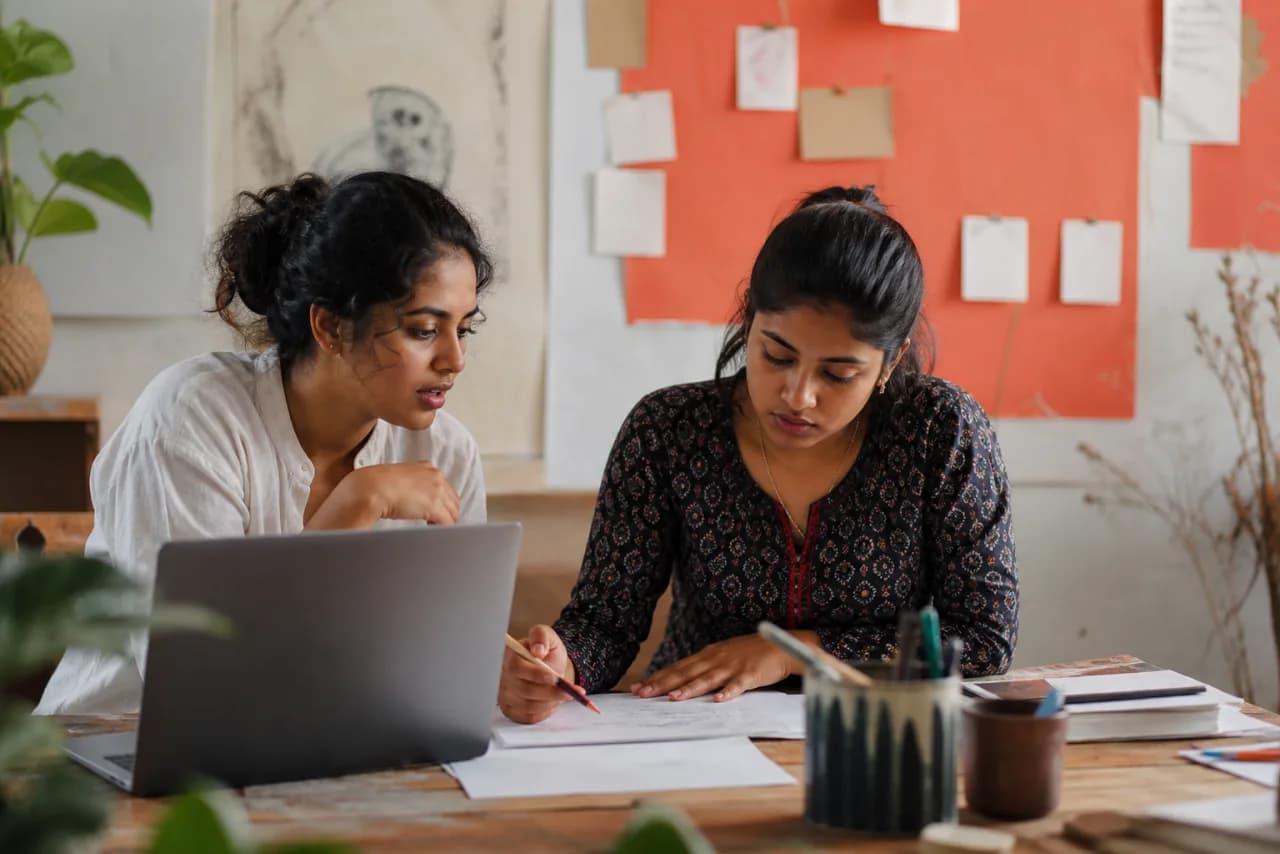 Two Bengali-speaking friends proofreading a voice-typed event description together